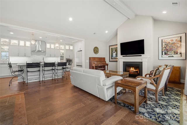 living room with high vaulted ceiling, dark hardwood / wood-style floors, and beam ceiling