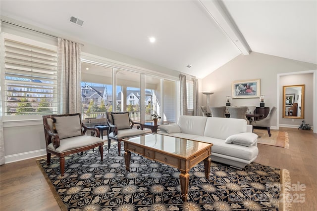 living room featuring vaulted ceiling with beams and hardwood / wood-style floors