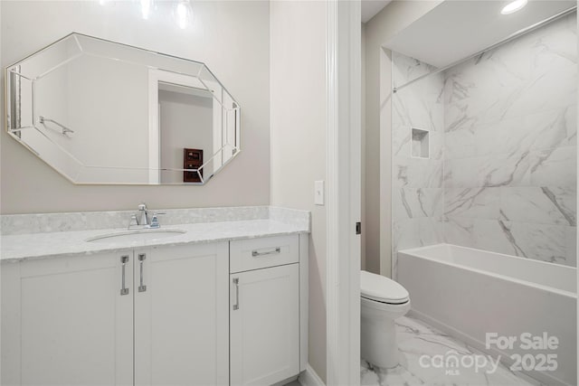 full bathroom with vanity, tiled shower / bath combo, and toilet