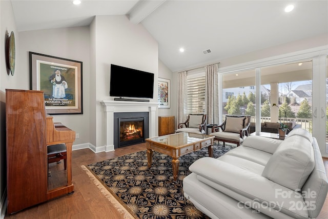 living room featuring wood-type flooring, beam ceiling, and high vaulted ceiling