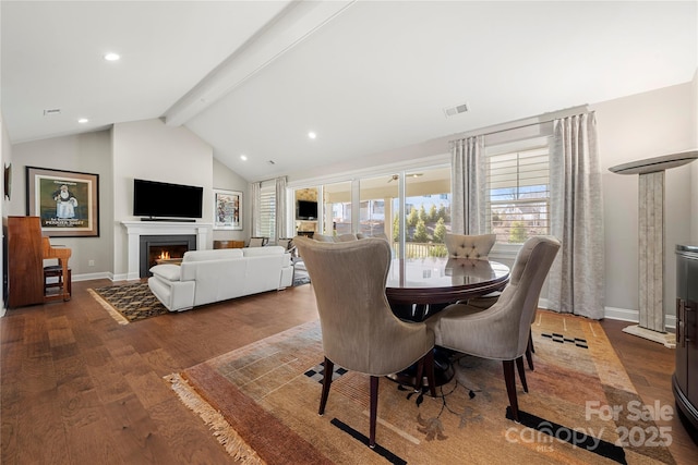 dining area featuring lofted ceiling with beams and hardwood / wood-style floors