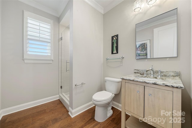 bathroom with crown molding, toilet, a shower with shower door, and hardwood / wood-style flooring