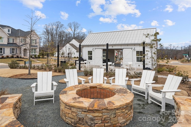 view of patio with an outbuilding and a fire pit