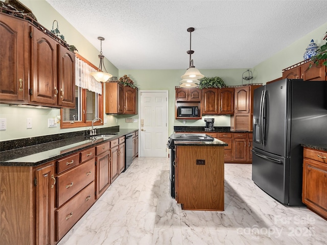 kitchen featuring sink, a textured ceiling, a kitchen island, pendant lighting, and black appliances