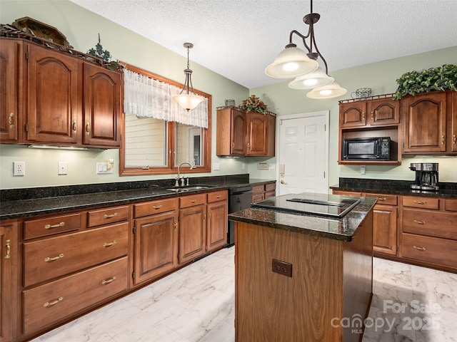 kitchen featuring decorative light fixtures, sink, a center island, black appliances, and a textured ceiling