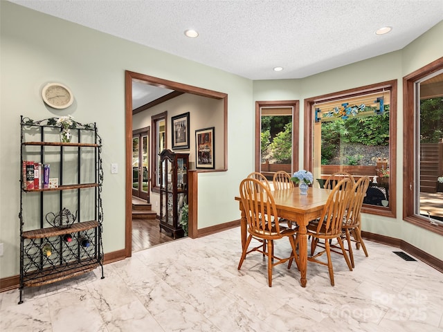 dining space featuring a textured ceiling