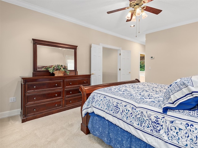 carpeted bedroom featuring crown molding and ceiling fan