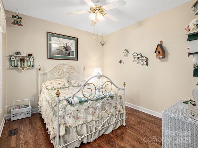 bedroom with dark wood-type flooring and ceiling fan