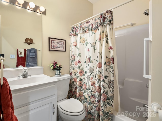 bathroom with walk in shower, vanity, and toilet