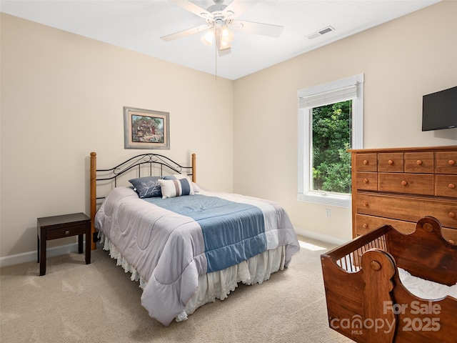 bedroom featuring light carpet and ceiling fan