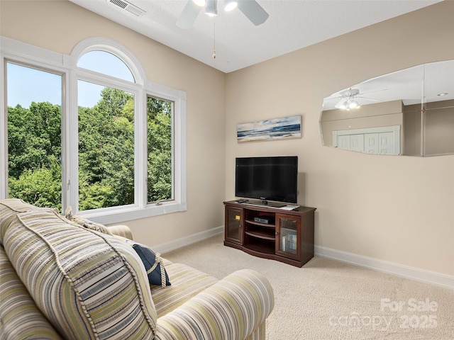 living room featuring light colored carpet and ceiling fan