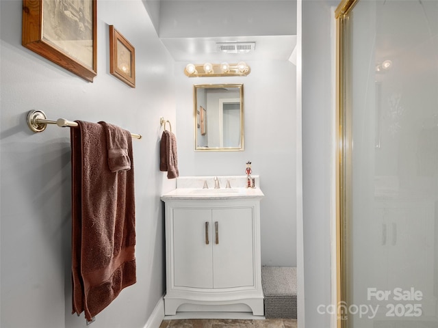 bathroom featuring vanity and an enclosed shower