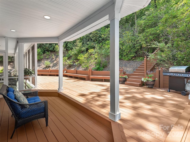 wooden deck featuring a grill