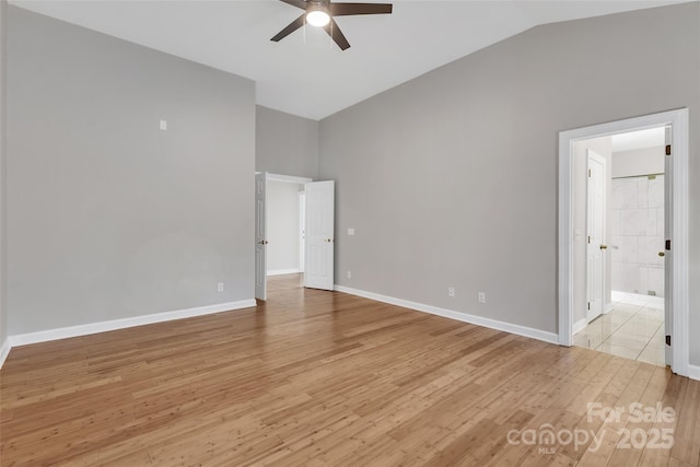 unfurnished bedroom with vaulted ceiling, ceiling fan, ensuite bathroom, and light hardwood / wood-style floors