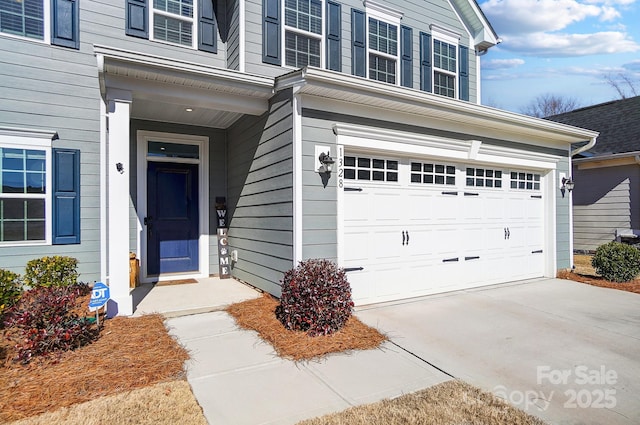 view of exterior entry with a garage