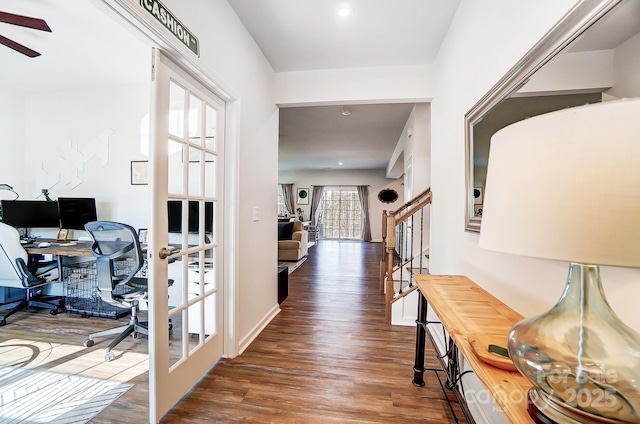 corridor with dark hardwood / wood-style floors and french doors