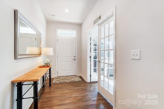 doorway to outside with dark hardwood / wood-style flooring and french doors