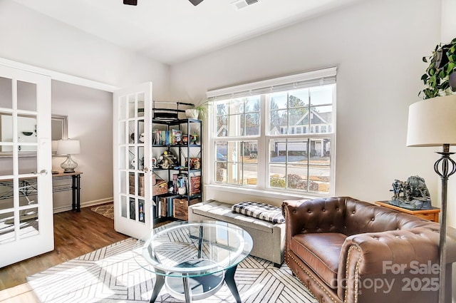 sitting room featuring french doors, ceiling fan, and hardwood / wood-style floors