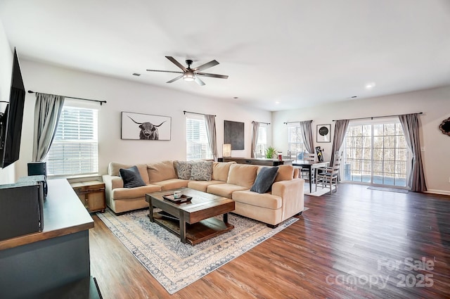 living room featuring wood-type flooring and ceiling fan