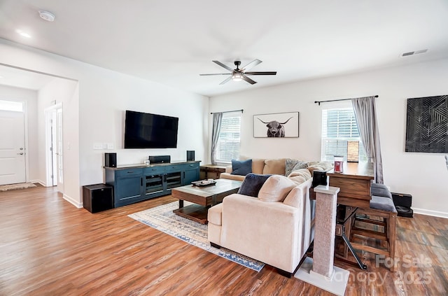 living room featuring ceiling fan and light wood-type flooring