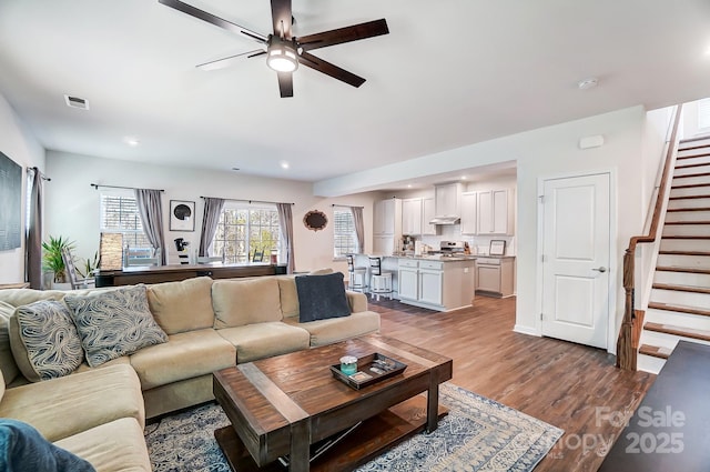 living room with hardwood / wood-style flooring and ceiling fan