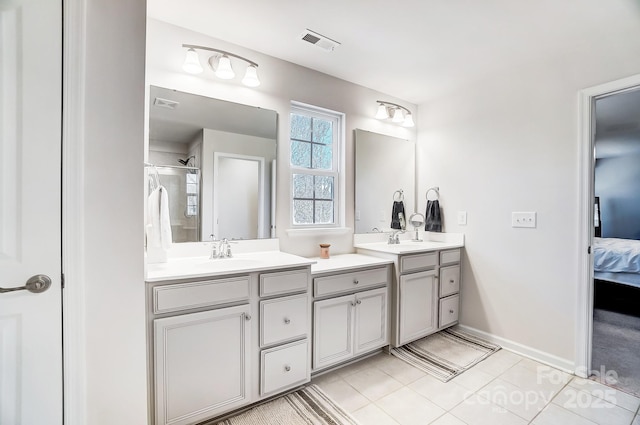 bathroom featuring vanity, an enclosed shower, and tile patterned flooring