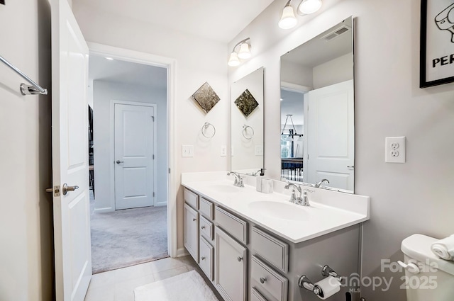 bathroom featuring vanity and toilet