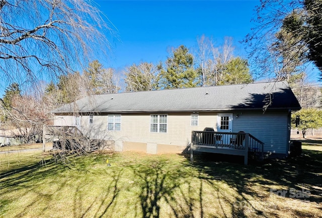 back of house with a deck and a lawn