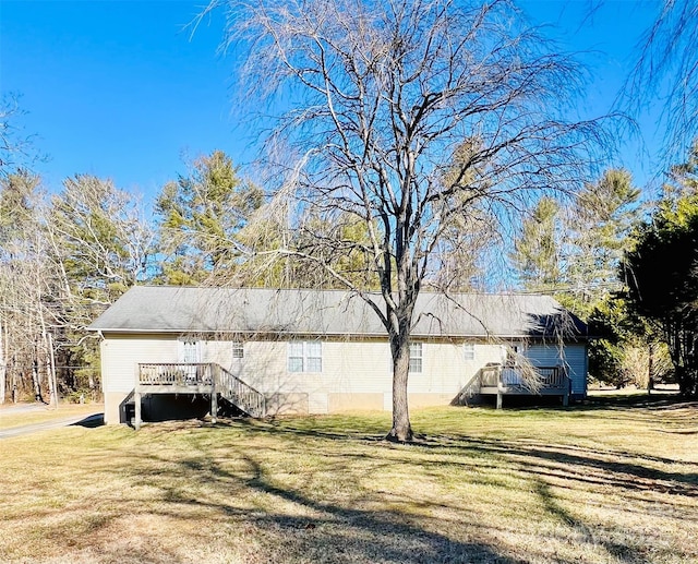 view of side of home with a lawn and a deck