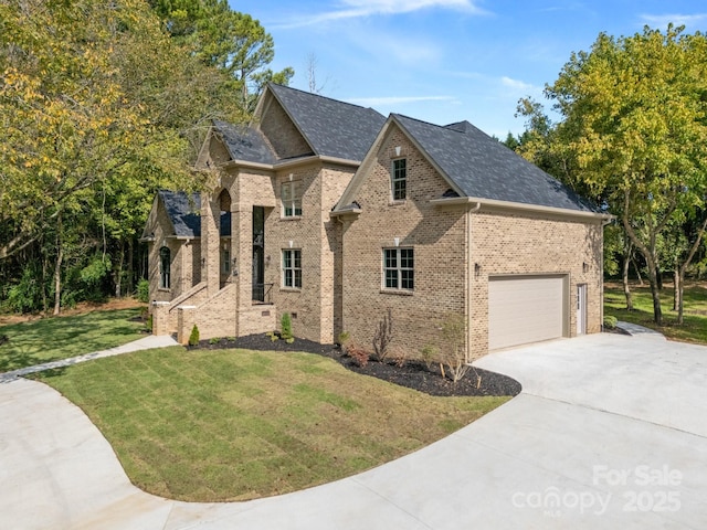 view of front of property featuring a garage and a front yard