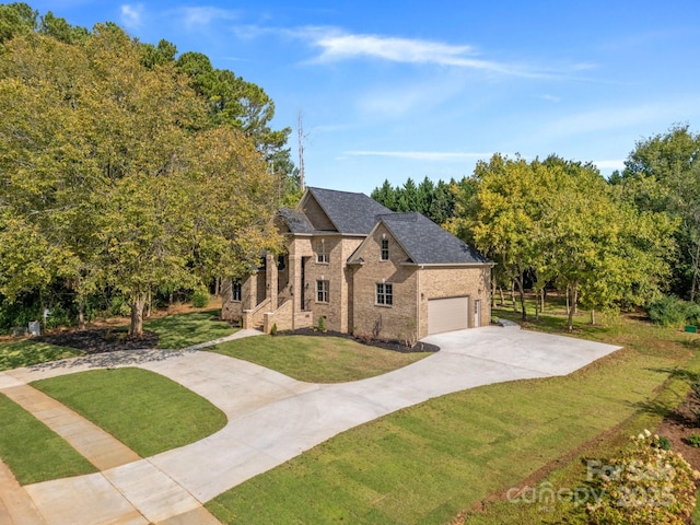 view of front of property with a garage and a front lawn