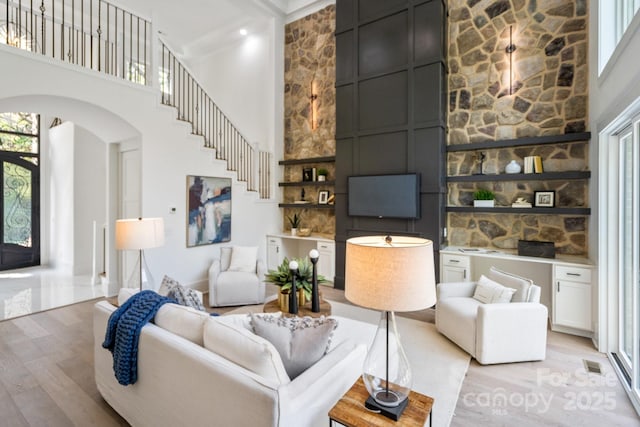 living room featuring a high ceiling and light wood-type flooring