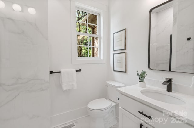 bathroom featuring vanity and toilet