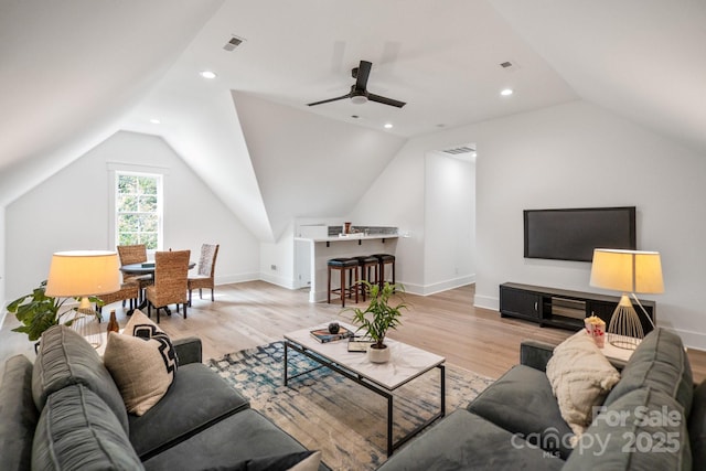 living room with vaulted ceiling and light hardwood / wood-style flooring