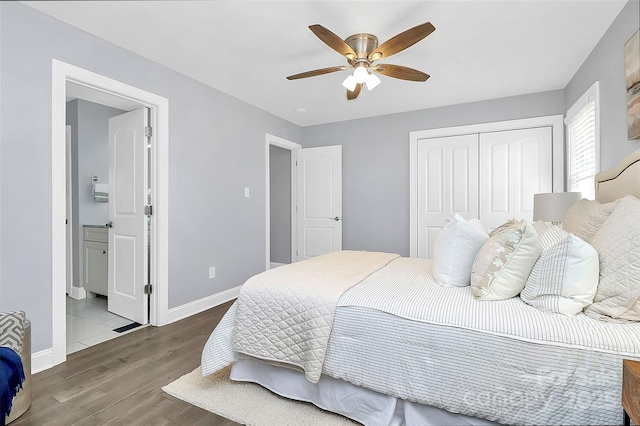 bedroom with hardwood / wood-style floors, a closet, ceiling fan, and ensuite bathroom