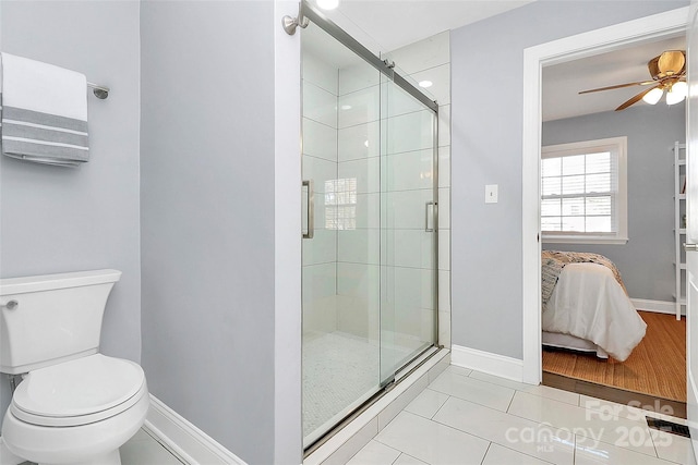 bathroom with ceiling fan, an enclosed shower, tile patterned floors, and toilet