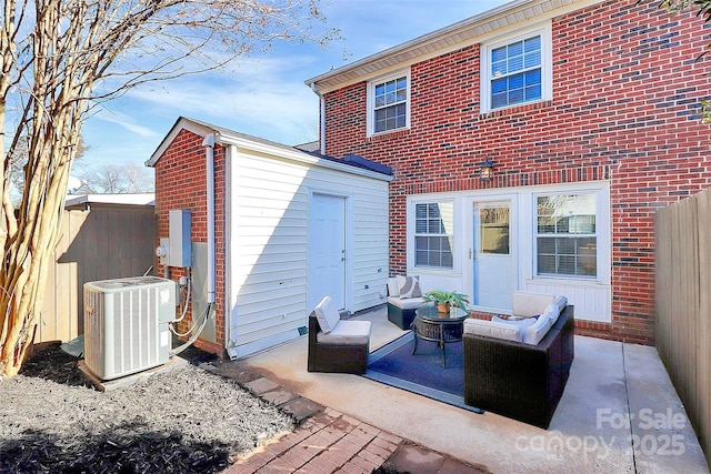 back of house featuring an outdoor living space, a patio area, and central air condition unit