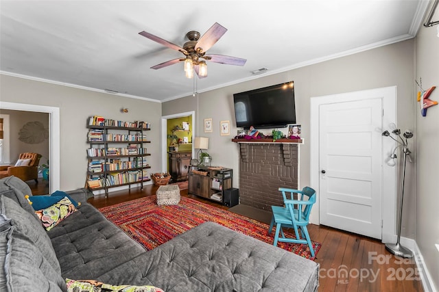 living room with crown molding, ceiling fan, and dark hardwood / wood-style flooring