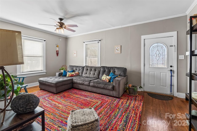 living room featuring hardwood / wood-style floors, a wealth of natural light, ornamental molding, and ceiling fan