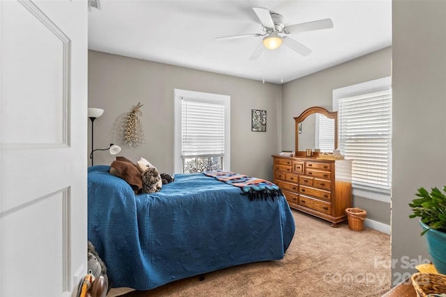 bedroom featuring light carpet and ceiling fan