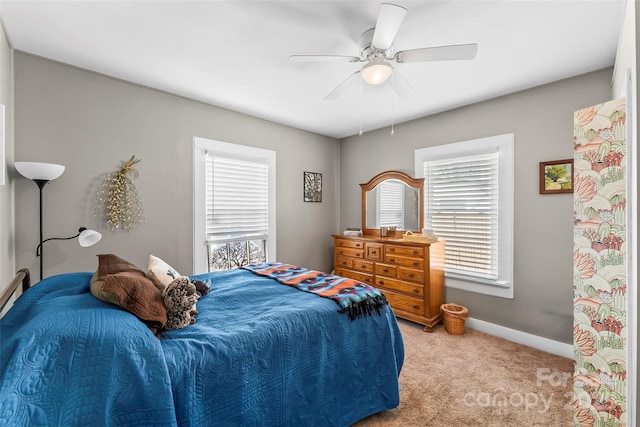 carpeted bedroom with multiple windows and ceiling fan