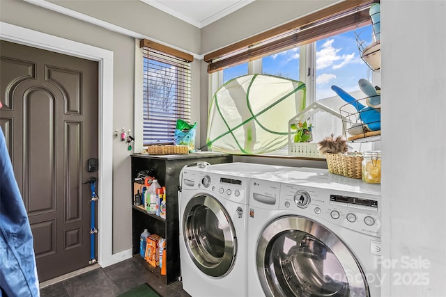 clothes washing area featuring crown molding and washer and dryer