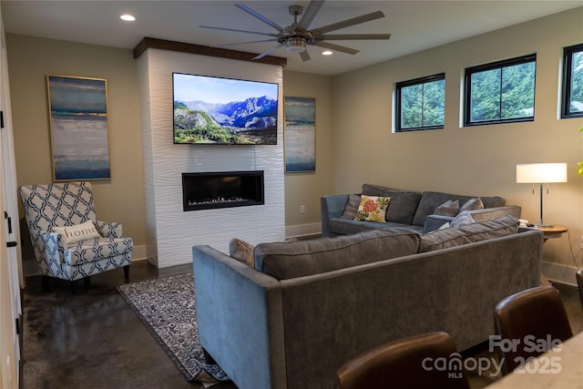 living room with a large fireplace and ceiling fan