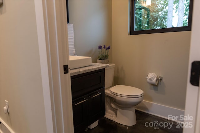 bathroom featuring vanity and toilet