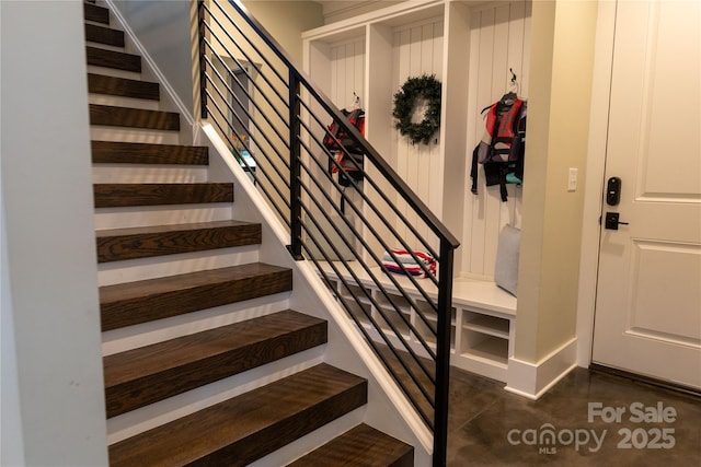 stairway featuring concrete flooring