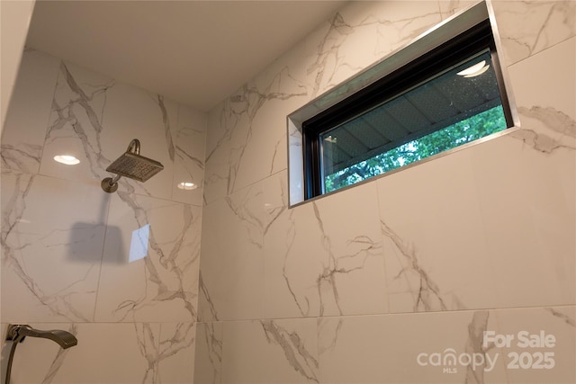 bathroom featuring walk in shower and plenty of natural light