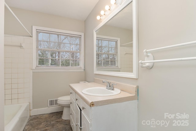 full bathroom with vanity, toilet, and tiled shower / bath combo