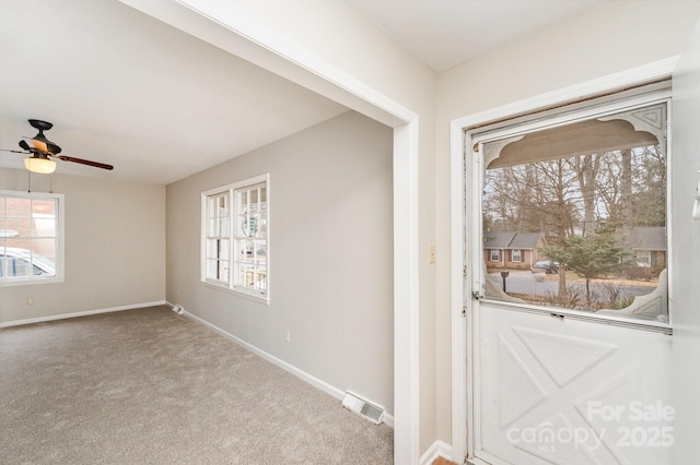 interior space featuring light colored carpet and ceiling fan