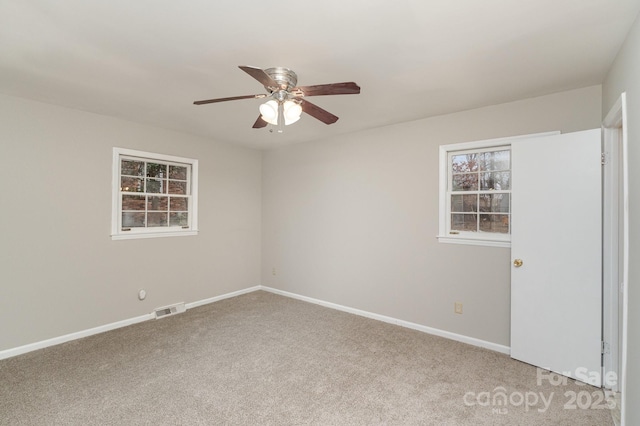 unfurnished room with ceiling fan and carpet floors