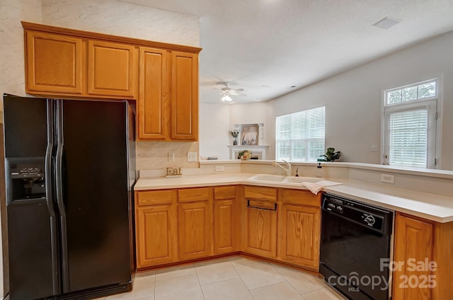 kitchen featuring black appliances, ceiling fan, light tile patterned floors, sink, and kitchen peninsula